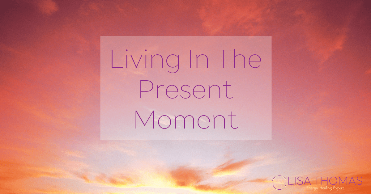 "Living in the Present Moment" against a pink and orange sunset