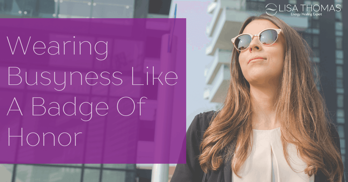"Wearing Busyness Like A Badge Of Honor" - a woman wearing sunglasses next to tall buildings